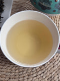 Emerald green Darjeeling green tea brewed light golden liquor in cup Brook37