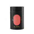 Brooke 7 first bloom tea in a black cylindrical tin with a pink oval label and gold lettering, set against a plain white background.